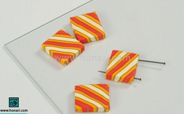 آموزش دستبند خمیری-مرحله 7 با استفاده از جسم نوک تیز مانند میخ یا خلال دندان دو دو طرف مربع ها سوراخ کوچکی برای عبور کش ایجاد میکنیم