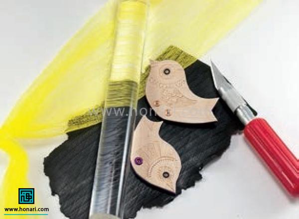 آموزش ساخت پیکسل با طرح پرنده-مرحله 11 پرنده ها رو روی خمیر مشکی بافت دار قرار می دیم و با وردنه به آرامی فشار می دیم تا هر سه لایه ی خمیر به هم بچسبن و اطراف اون ها رو برش می زنیم.