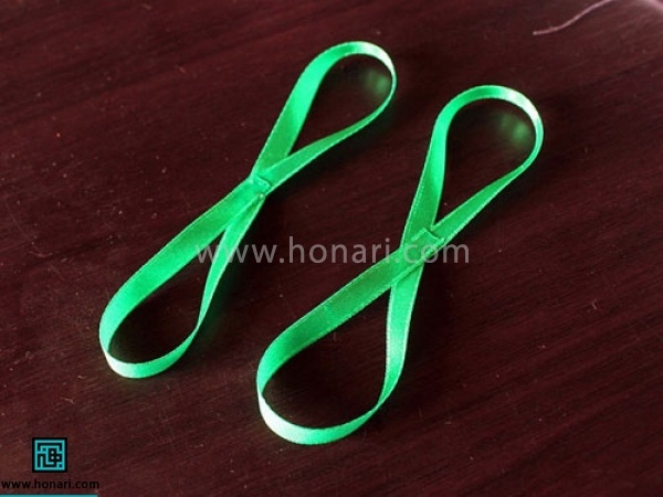 روبان نیم سانتی را به دوقسمت مساوی کرده از وسط یک پیچ میدهید و چسب میزنید